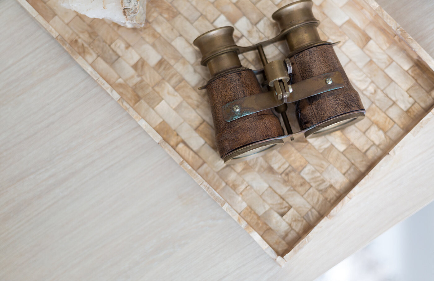 Antique binoculars on a mother-of-pearl tray